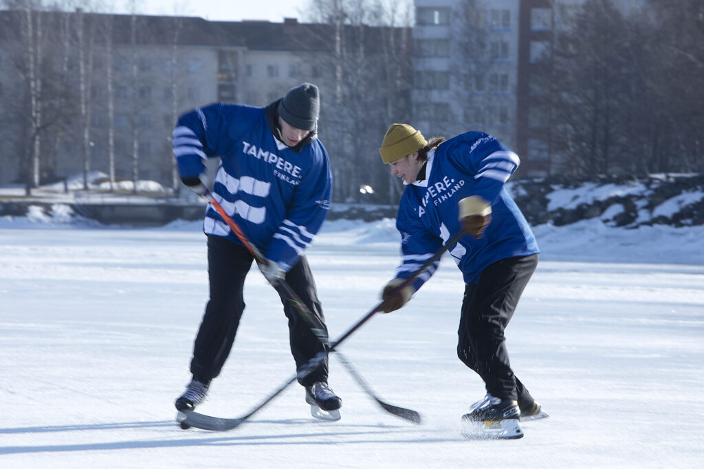 People playing ice hockey in open air.